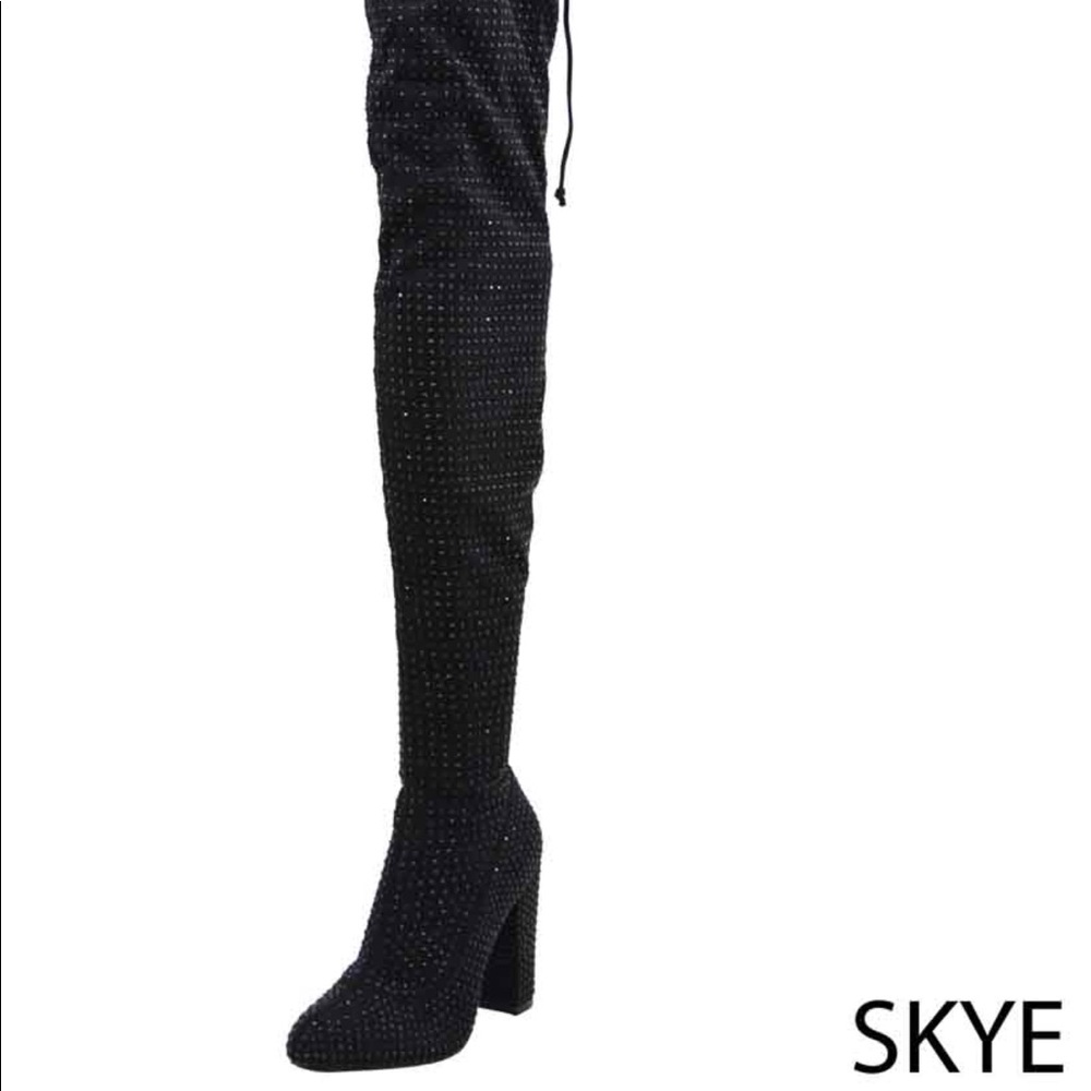 Thigh high bedazzled boot.
